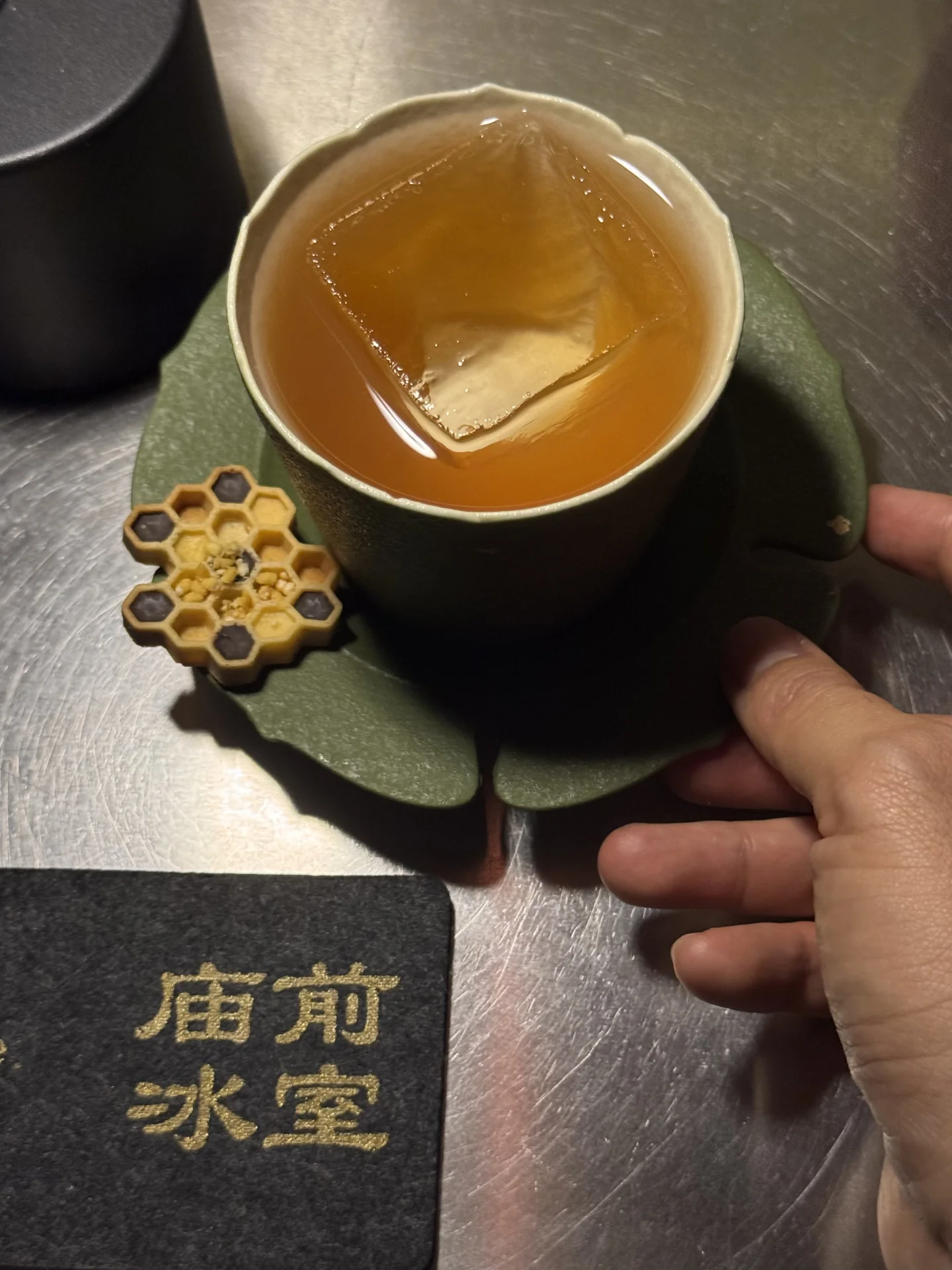Cocktail served in a ceramic cup beside a Hope and Sesame branded napkin in Guangzhou