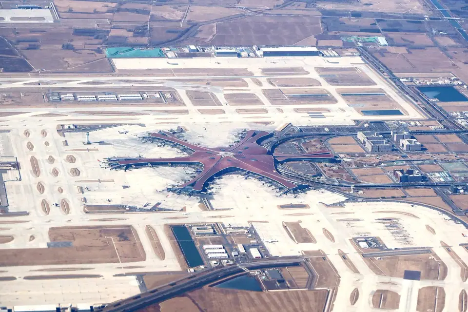 Aerial view of the star-shaped terminal and concourses at Beijing Daxing International Airport
