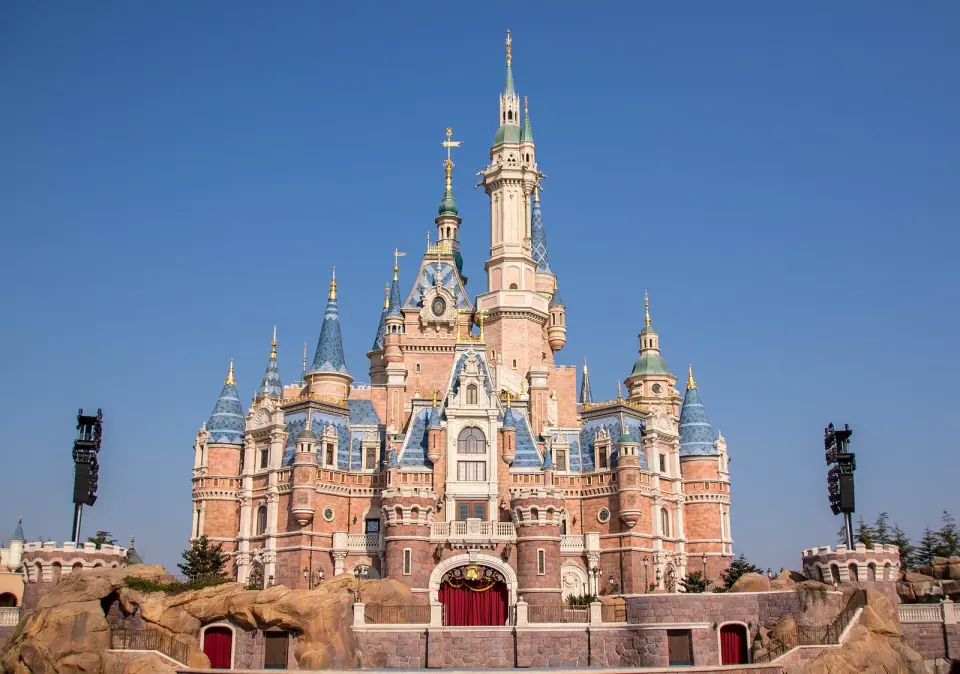 Enchanted Storybook Castle at Shanghai Disneyland beneath a clear blue sky