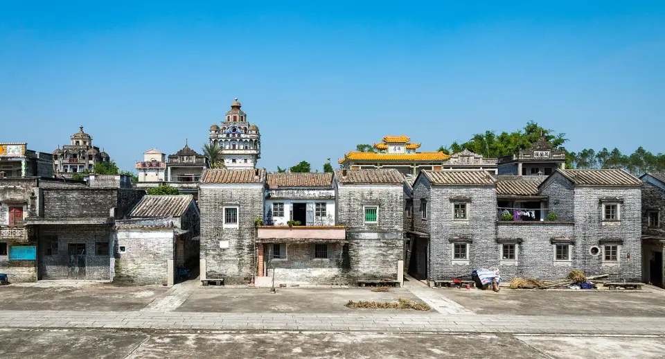 Historic gateway and tiled village buildings in Jinjiangli, Kaiping