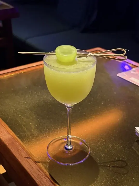 Pale green cocktail garnished with lime at Bar Lotus in Chengdu