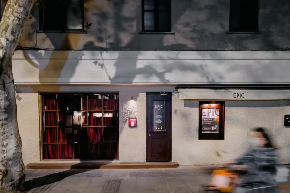 EPIC bar facade with a red doorway on a tree-lined Shanghai street