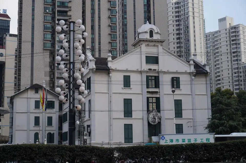 White facade and green shutters of the former Xujiahui convent, now Shanghai Old Station restaurant