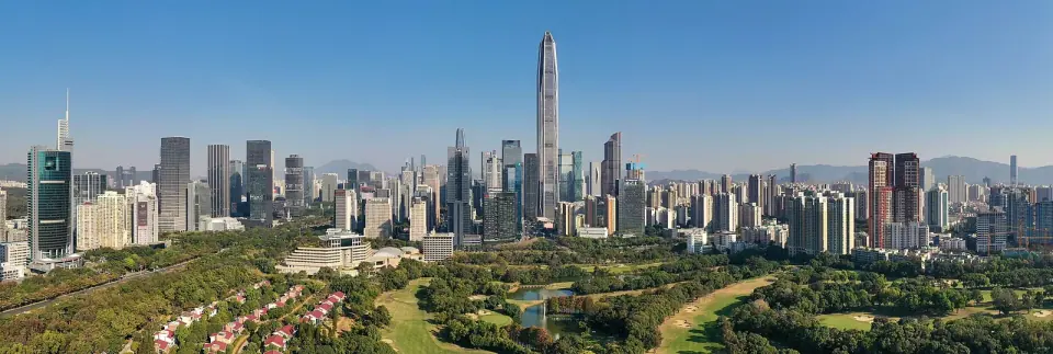 Futian skyline and Ping An Finance Center above green parkland in Shenzhen