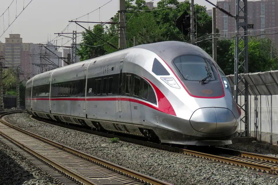 White Fuxing CR400AF high-speed train traveling along railway tracks in China