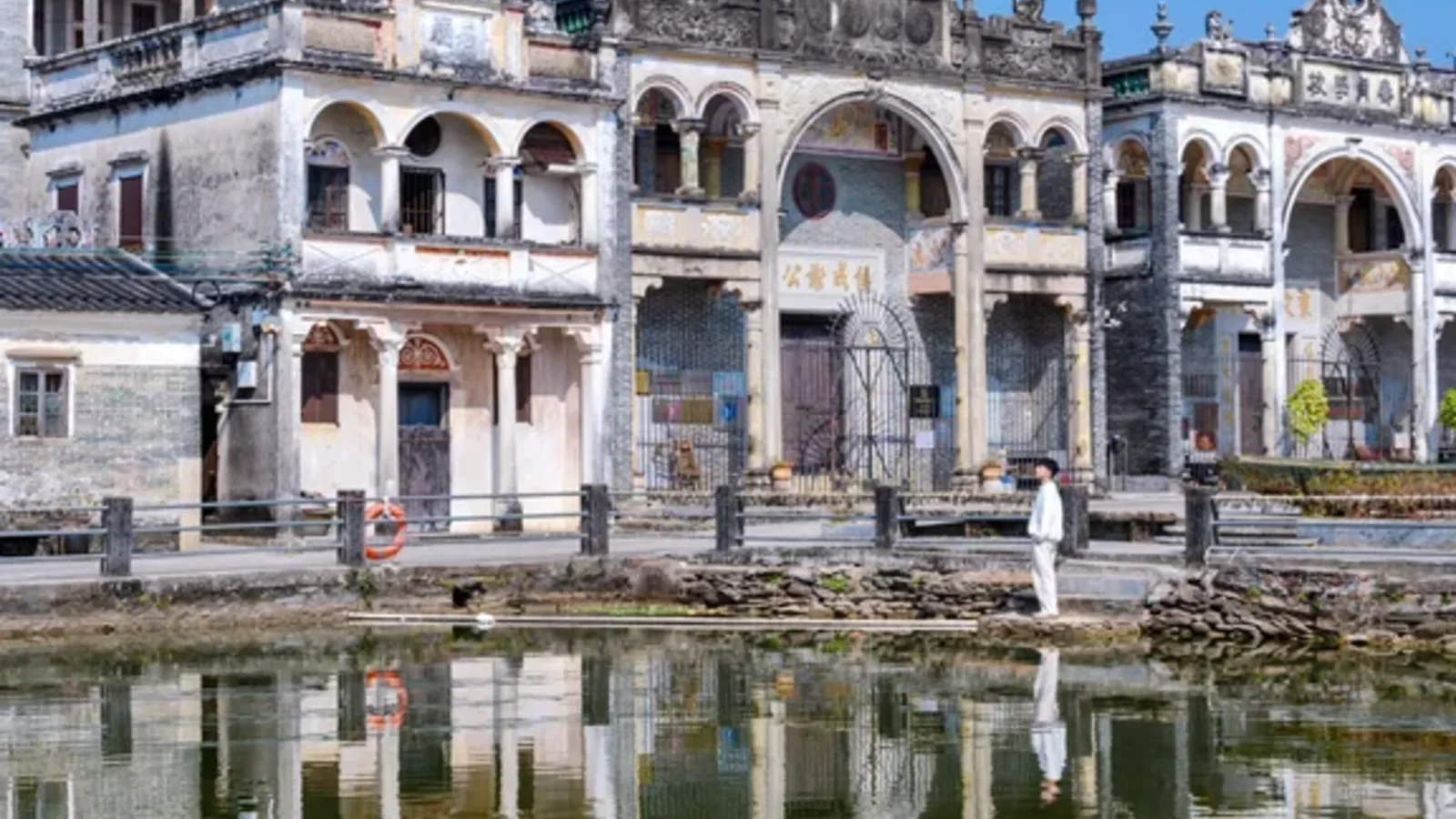 Historic diaolou beside a pond in Kaiping