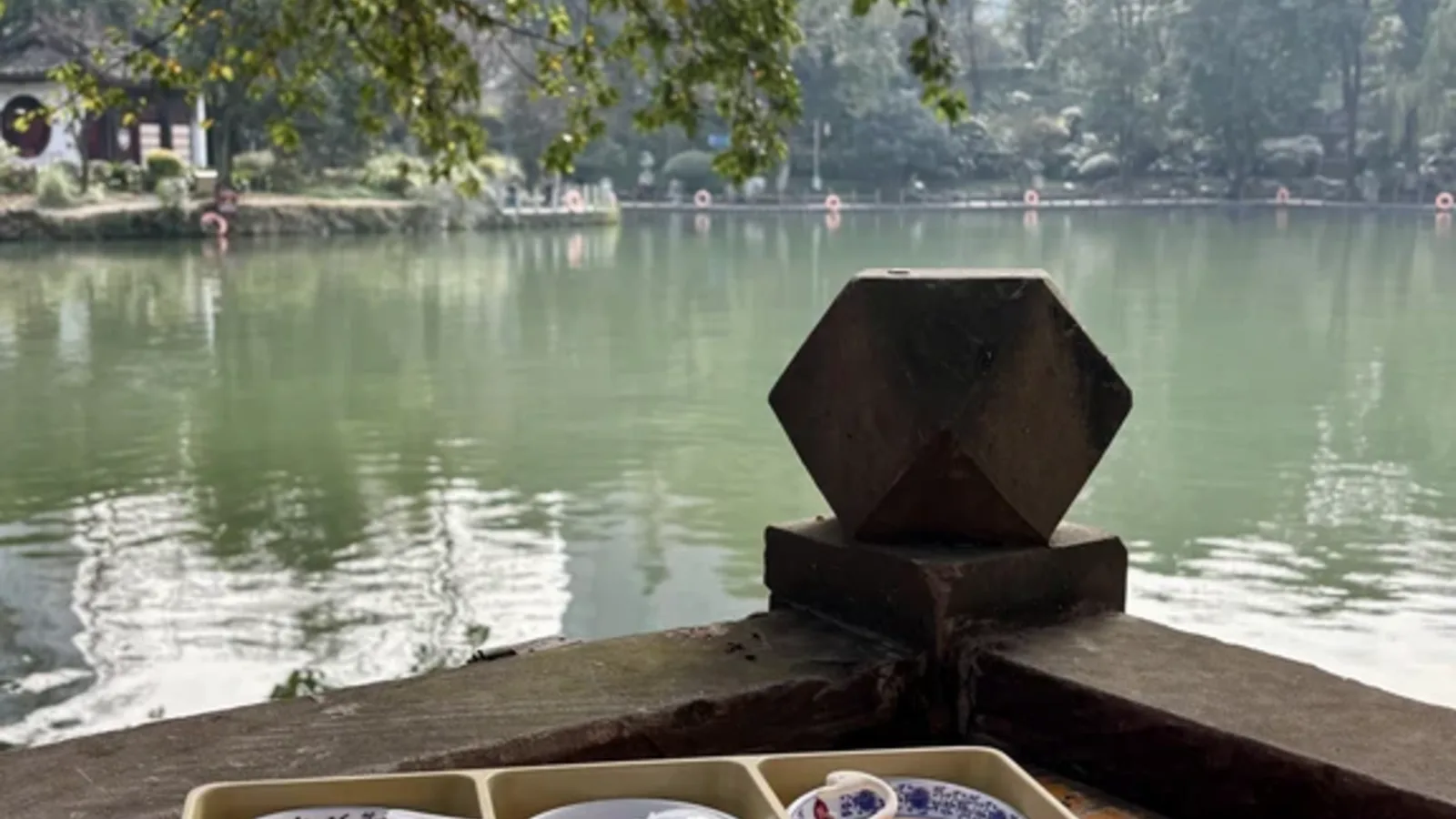 Gaiwan tea beside the lake at Heming Teahouse in Chengdu People's Park